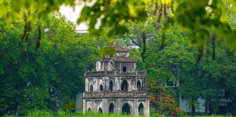 Hoan Kiem Lake ( Ho Guom) or Sword lake in the center of Hanoi with clear sky. Hoan Kiem Lake is a famous tourist place in Hanoi. Travel and landscape concept. Selective focus.